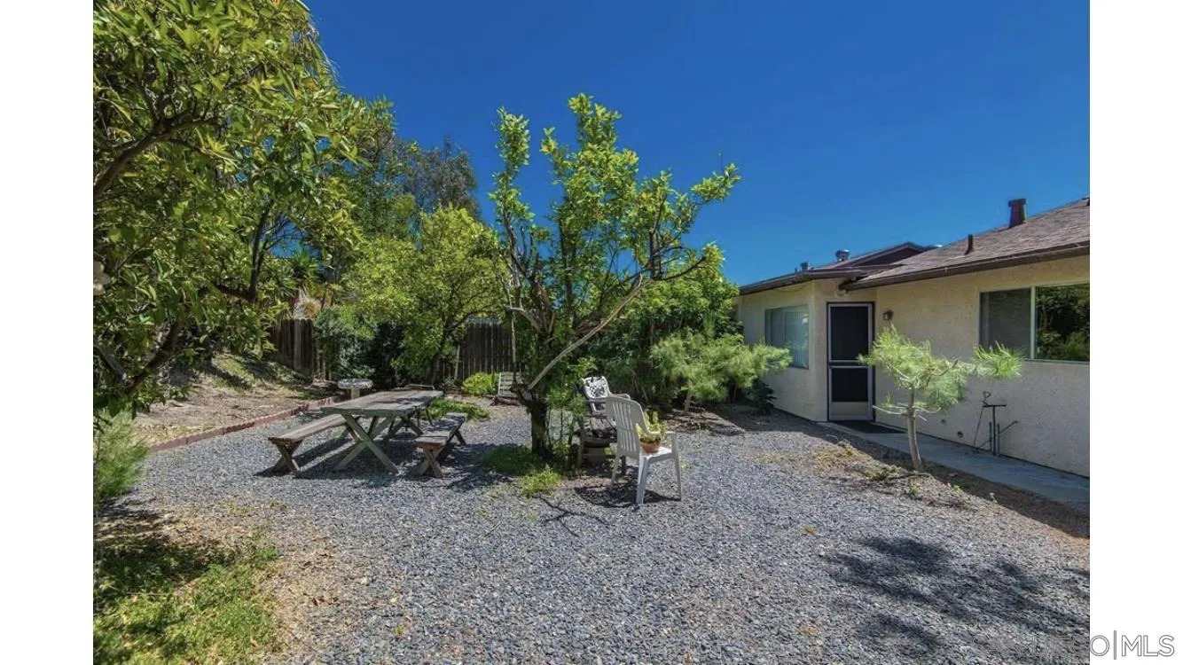 4704 Rim Rock Road Oceanside, CA 92056 - Photo 3 of 11 a view of a house with backyard sitting area and garden