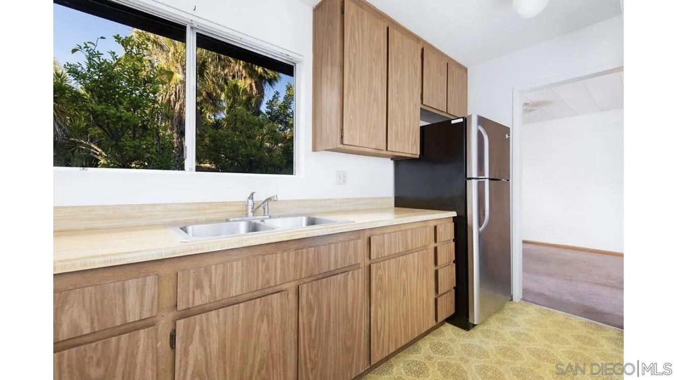 4704 Rim Rock Road Oceanside, CA 92056 - Photo 6 of 11 a kitchen with a sink and a refrigerator