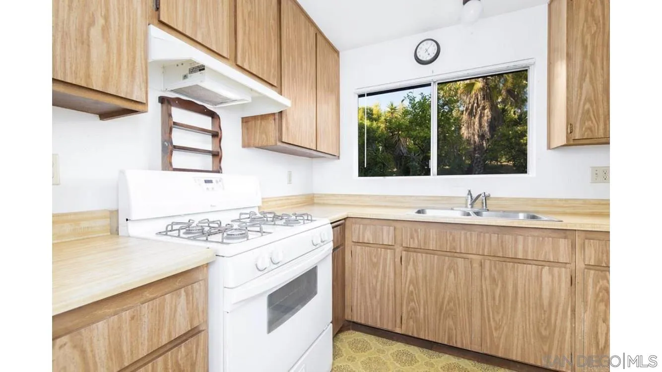 4704 Rim Rock Road Oceanside, CA 92056 - Photo 7 of 11 a kitchen with a stove a sink and a window