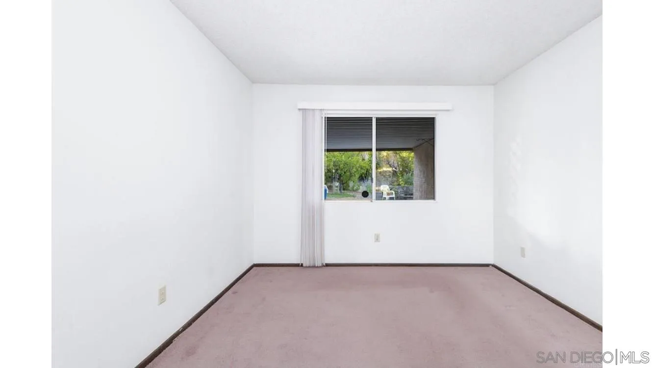 4704 Rim Rock Road Oceanside, CA 92056 - Photo 8 of 11 an empty room with a window