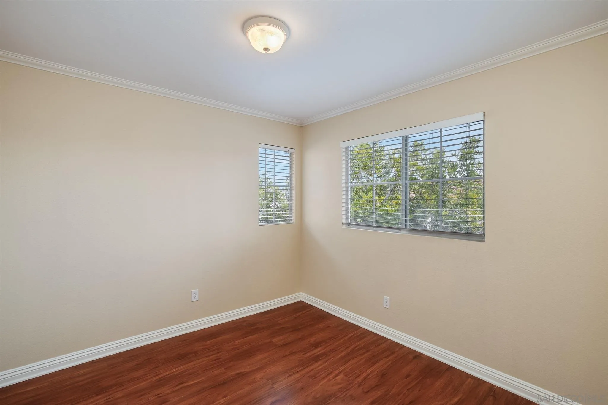 1983 Courage Street Vista, CA 92081 - Photo 19 of 33 an empty room with wooden floor and windows