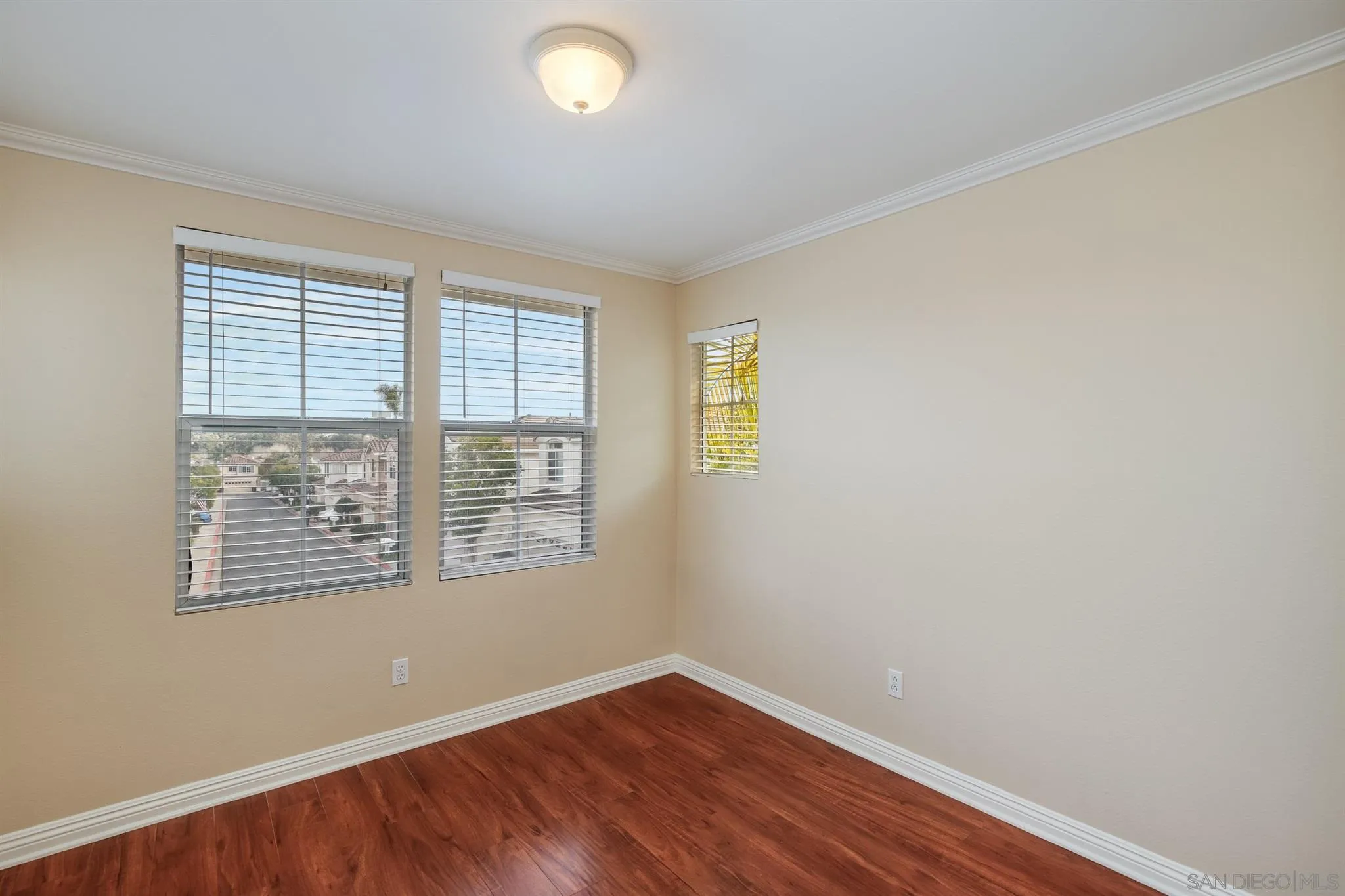 1983 Courage Street Vista, CA 92081 - Photo 20 of 33 a view of an empty room with wooden floor and a window