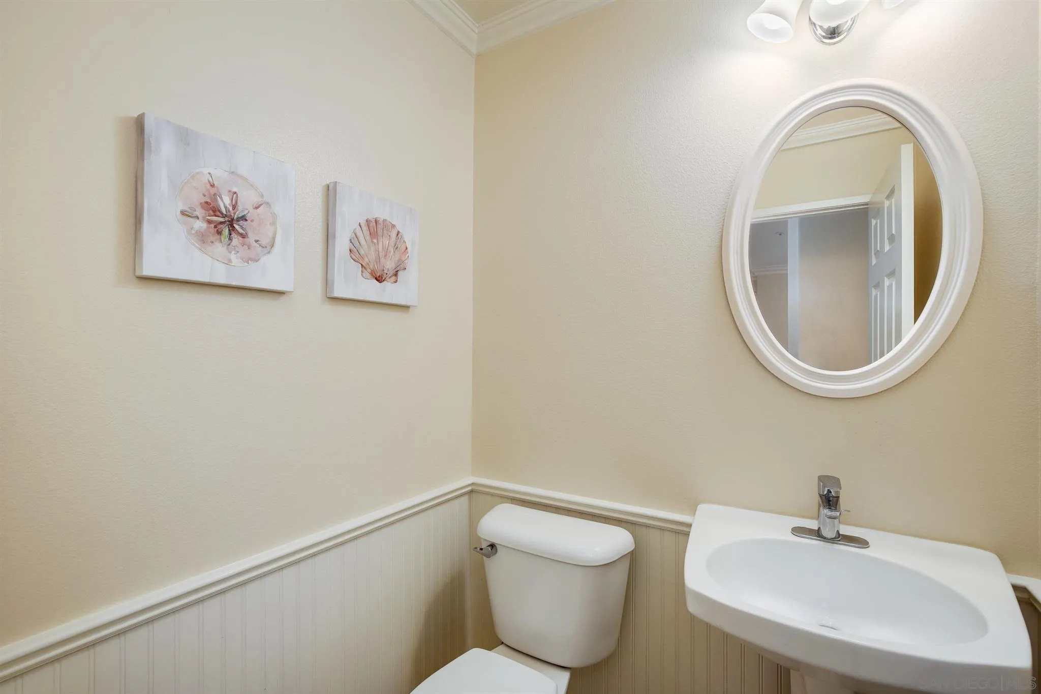 1983 Courage Street Vista, CA 92081 - Photo 21 of 33 a bathroom with a toilet a sink and a mirror