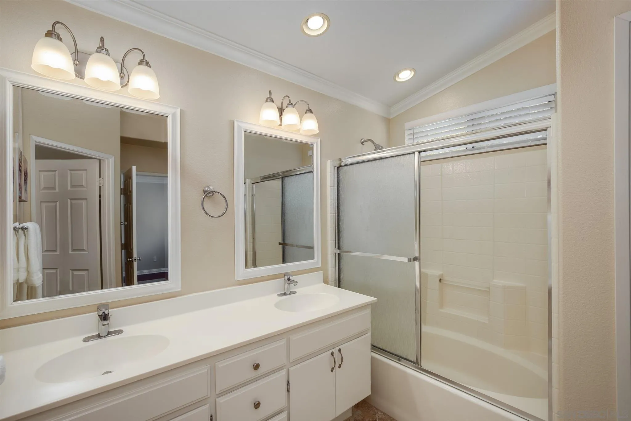 1983 Courage Street Vista, CA 92081 - Photo 23 of 33 a bathroom with a shower sink double vanity and mirror