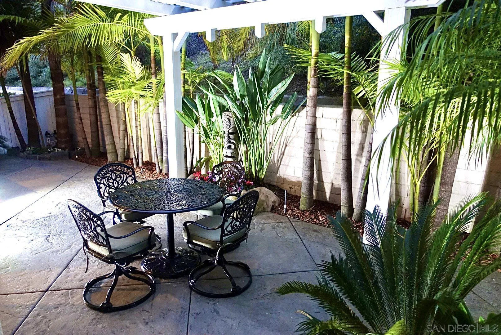 1983 Courage Street Vista, CA 92081 - Photo 31 of 33 a view of a backyard with table and chairs and a barbeque with potted plants
