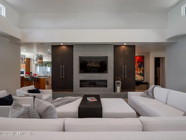 a living room with furniture and a potted plant