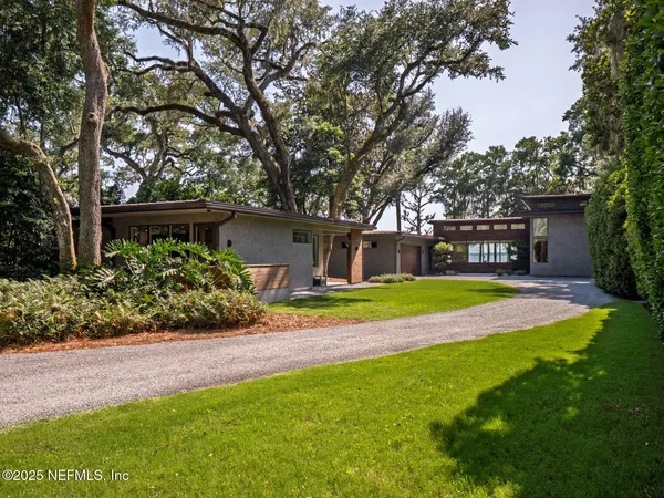 a view of a house with a yard and garage