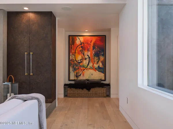 a bedroom with a bed and a mirror