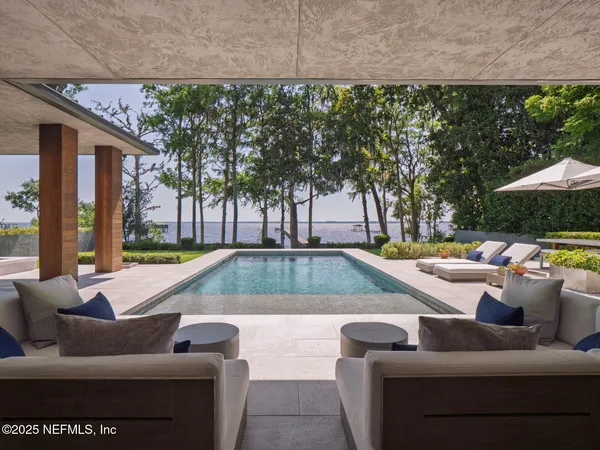 a view of a swimming pool with an outdoor seating