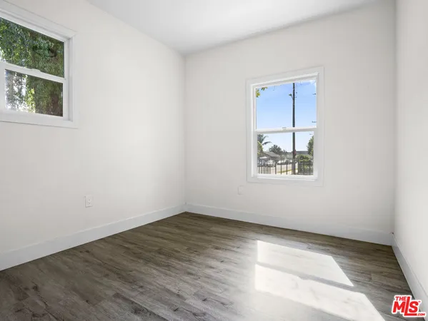 a kitchen with white cabinets and sink