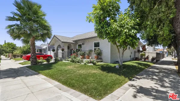 a view of backyard with outdoor seating and stairs
