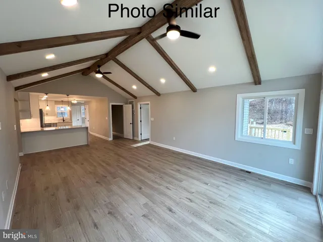 a view of an empty room and a window