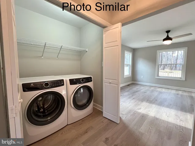 a view of a hallway with washer and dryer