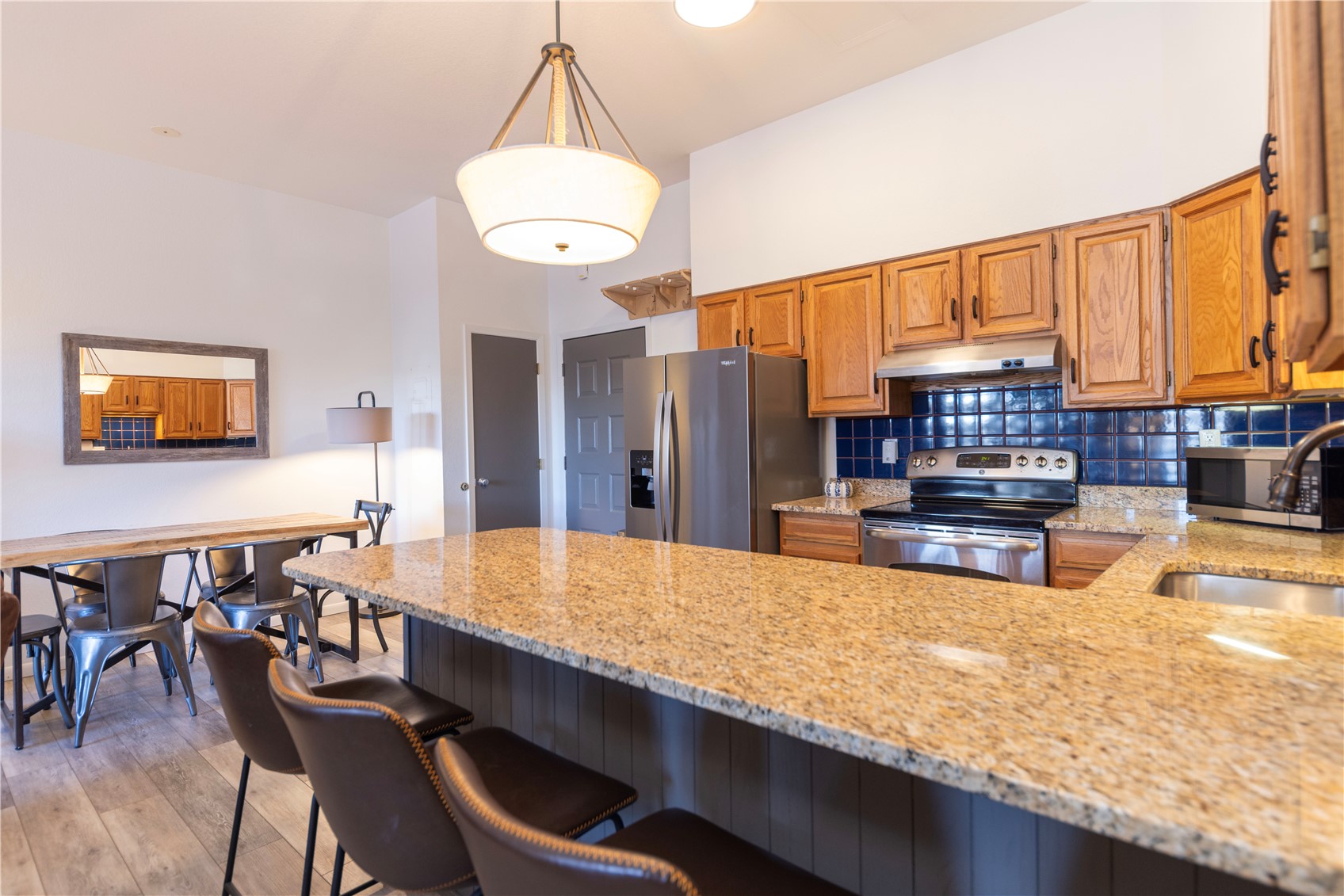 89410 Ryan Gulch Road, Unit 104 Silverthorne, CO 80498 - Photo 6 of 31 a large kitchen with a table and chairs