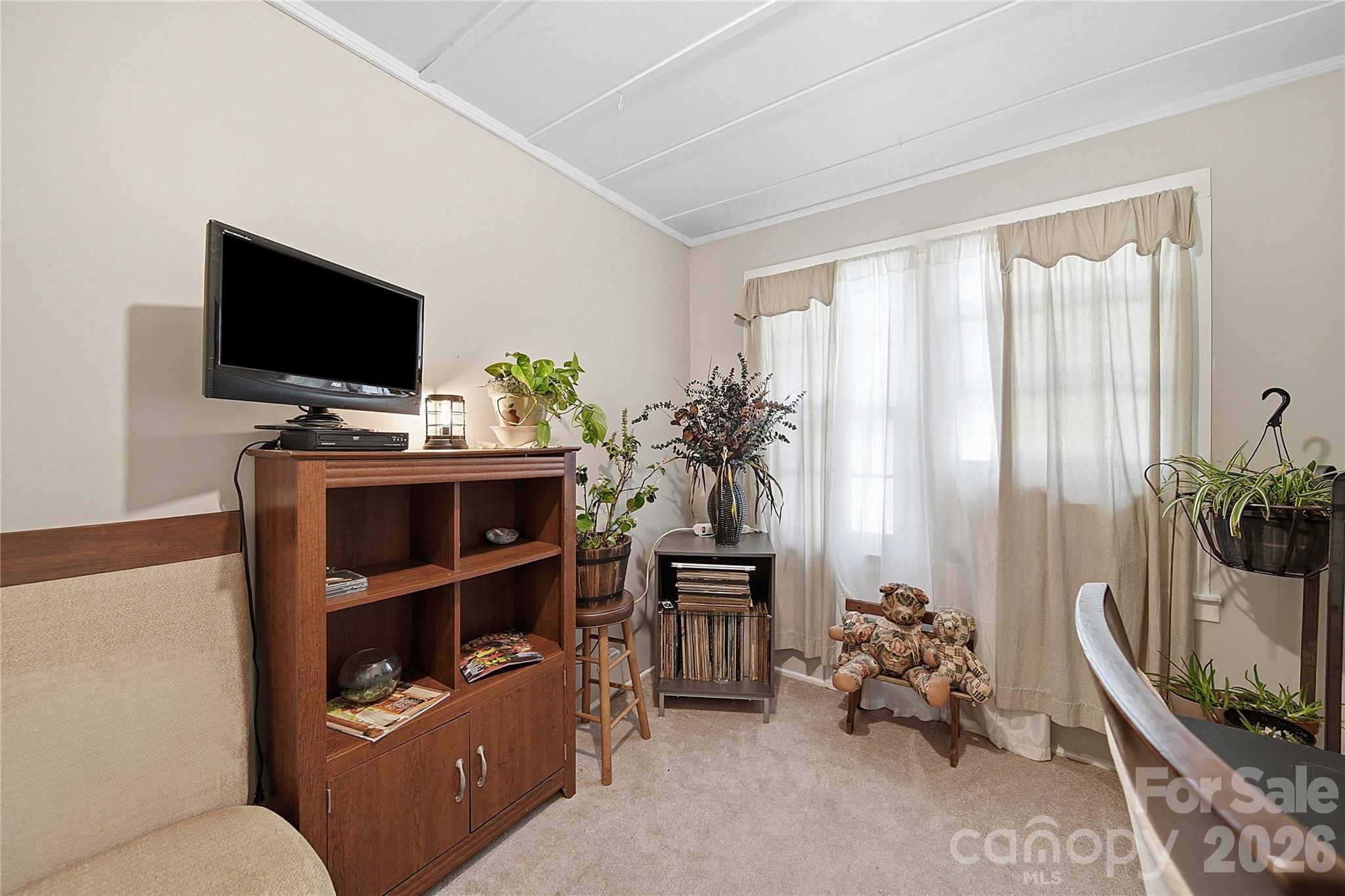 35 Boyden Street Badin, NC 28009 - Photo 14 of 36 a room with furniture and a flat screen tv