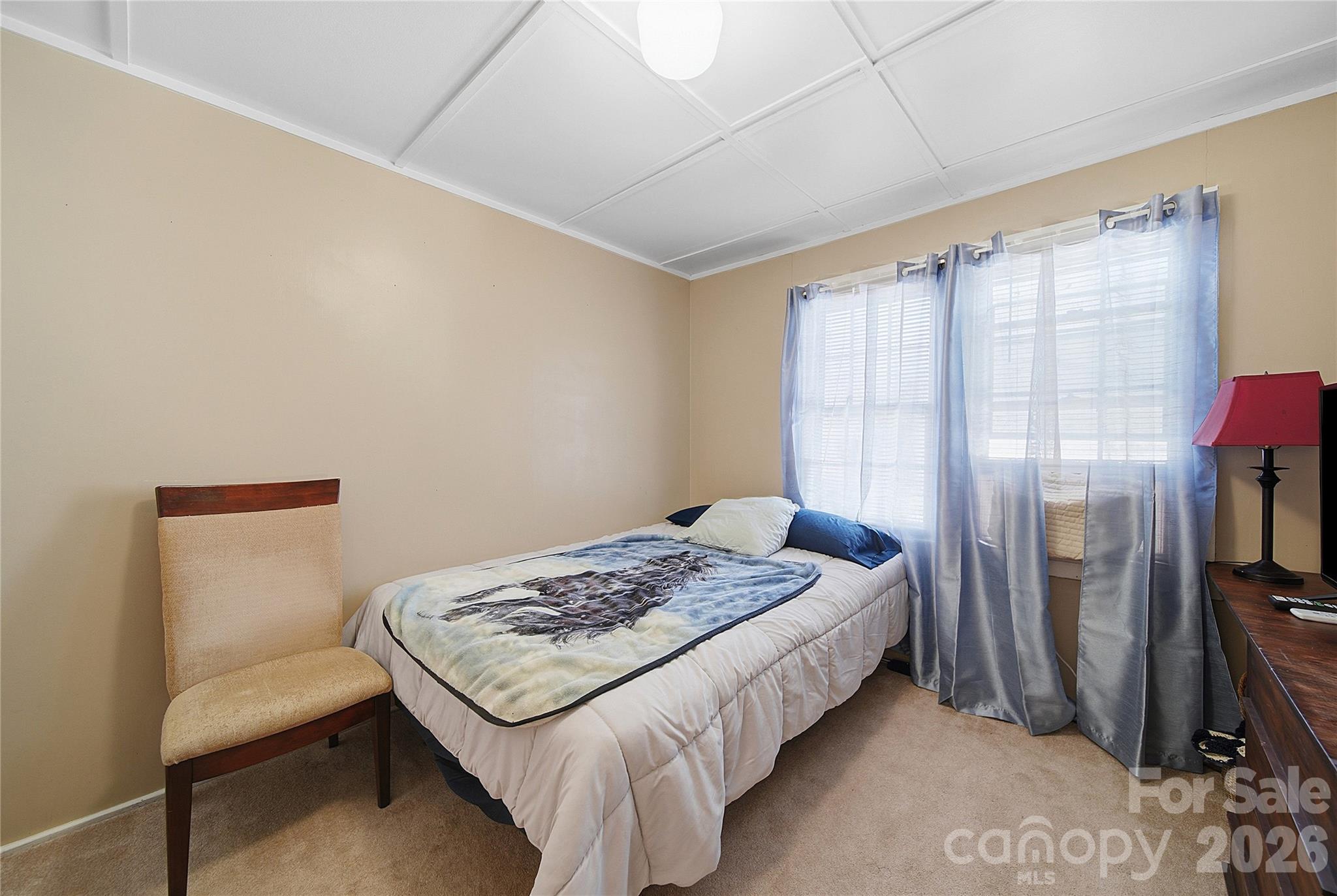 35 Boyden Street Badin, NC 28009 - Photo 16 of 36 a bedroom with a bed and a table in it