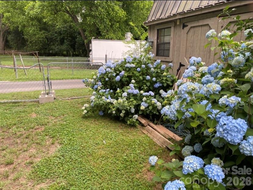 35 Boyden Street Badin, NC 28009 - Photo 36 of 36 a backyard of a house with lots of green space and garden view