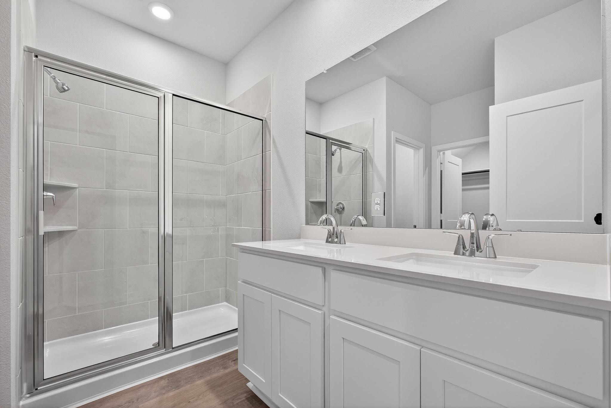 3922 Accolade Crossing Brookshire, TX 77423 - Photo 12 of 27 a bathroom with a double vanity sink mirror and shower