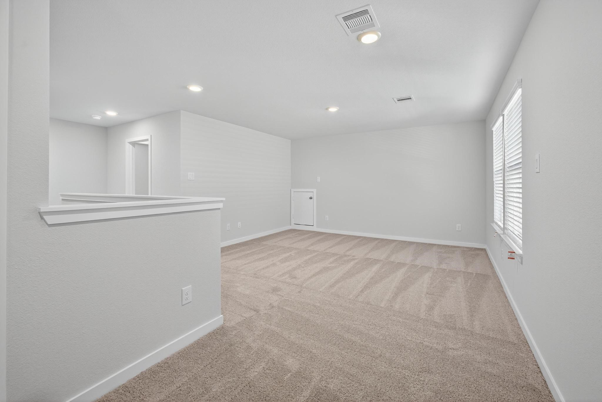3922 Accolade Crossing Brookshire, TX 77423 - Photo 13 of 27 wooden floor in an empty room with a window