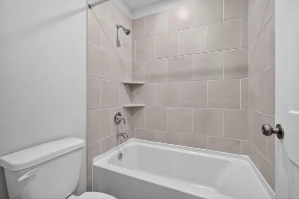 a bathroom with a bathtub and a toilet