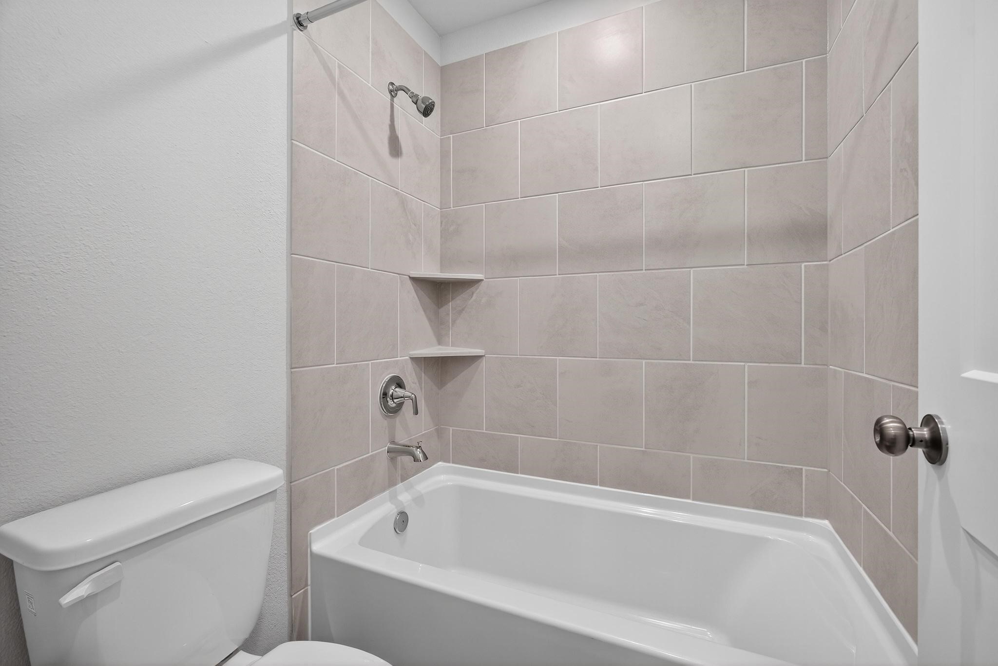 3922 Accolade Crossing Brookshire, TX 77423 - Photo 17 of 27 a bathroom with a bathtub and a toilet