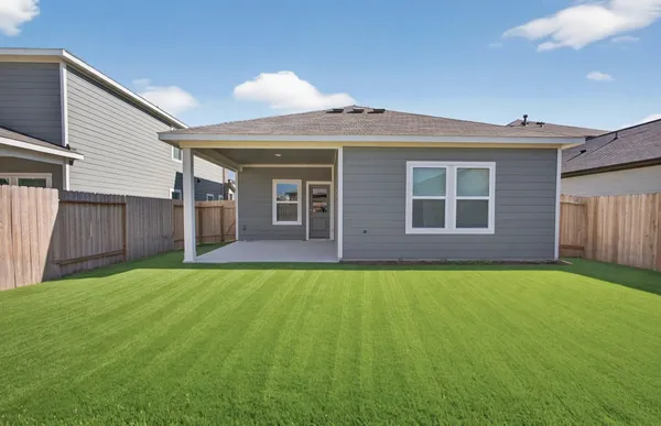 a view of a house with backyard and porch