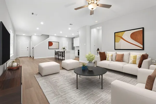 a living room with furniture and kitchen view