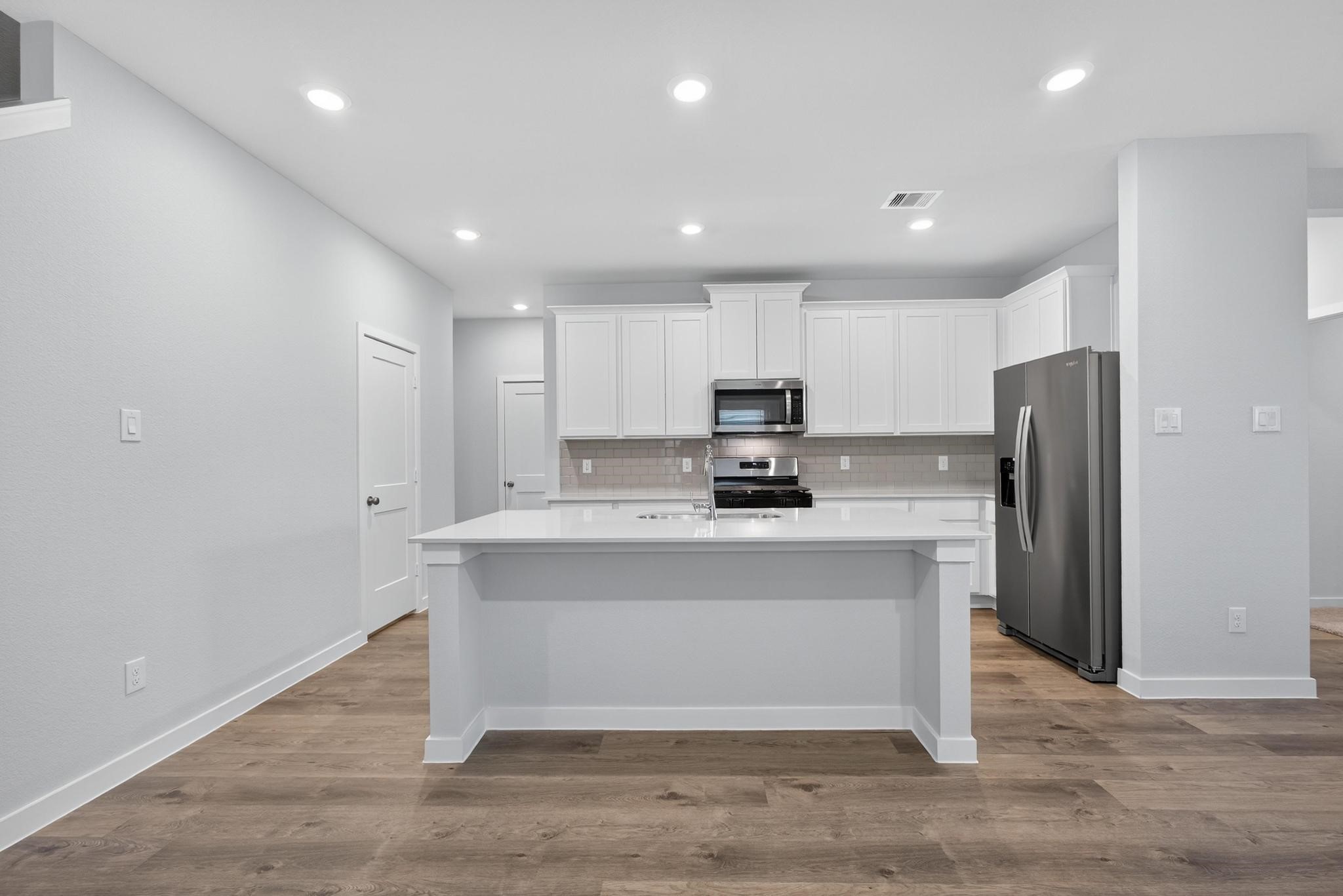 3922 Accolade Crossing Brookshire, TX 77423 - Photo 3 of 27 a view of kitchen with stainless steel appliances refrigerator sink and cabinets
