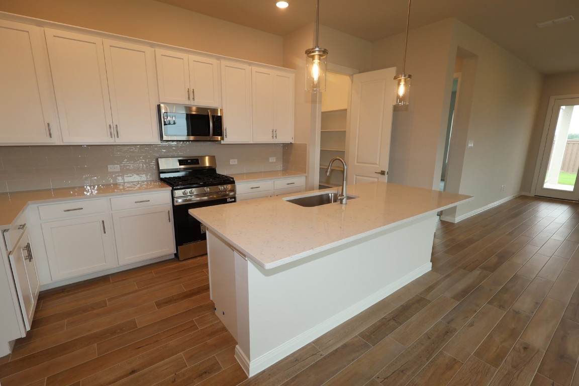 110 Afton June Drive Rosenberg, TX 77471 - Photo 7 of 19 a kitchen with a sink a stove and cabinets