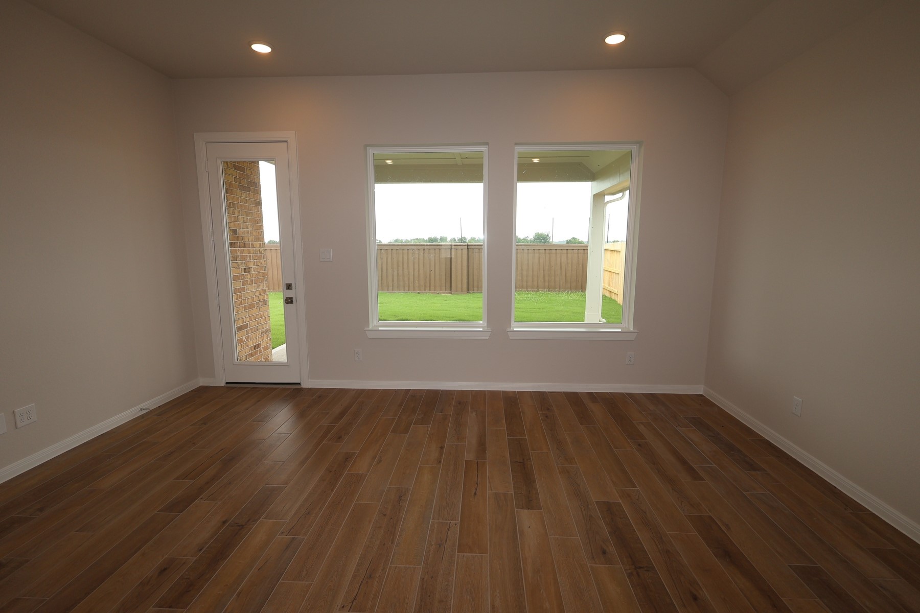 110 Afton June Drive Rosenberg, TX 77471 - Photo 9 of 19 an empty room with wooden floor and windows