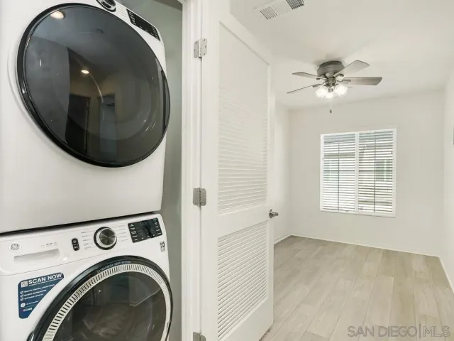 an entryway in wooden floor with a washer and dryer