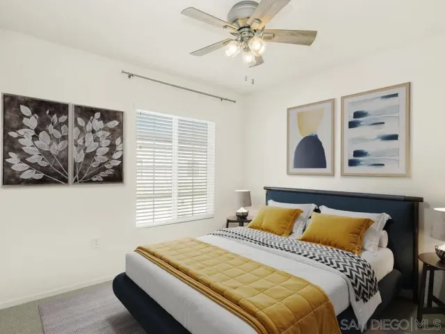 a bedroom with a bed and a painting on the wall