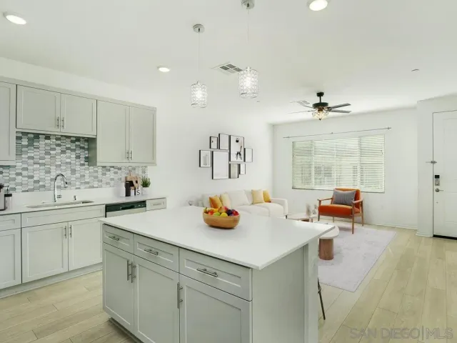 a kitchen with a sink a stove and cabinets