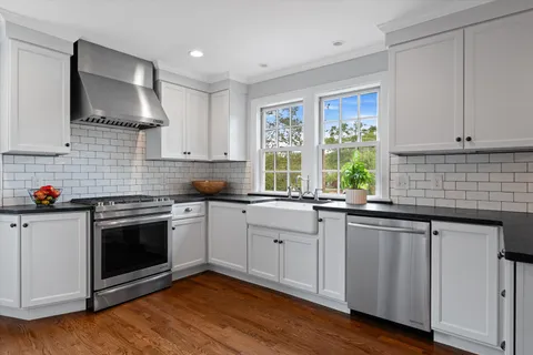a kitchen with a sink and large window