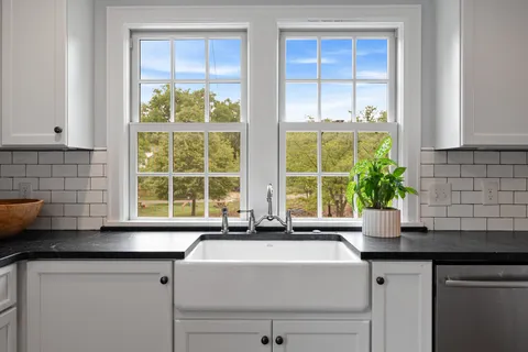a view of a kitchen with wooden floor and front door