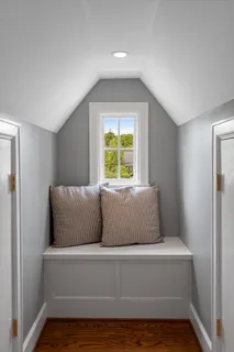 a bedroom with a bed and a table with wooden floor