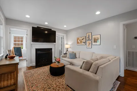 a living room with furniture a fireplace and a flat screen tv
