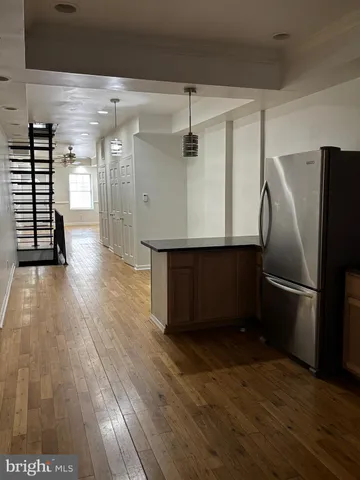 a kitchen with kitchen island a counter top space wooden floor and appliances