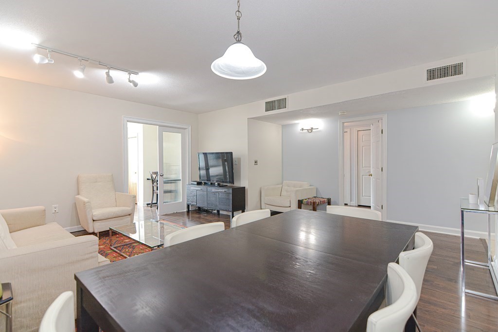 59 Brainerd Road, Unit 410 Boston, MA 02134 - Photo 11 of 41 a living room with furniture and a chandelier