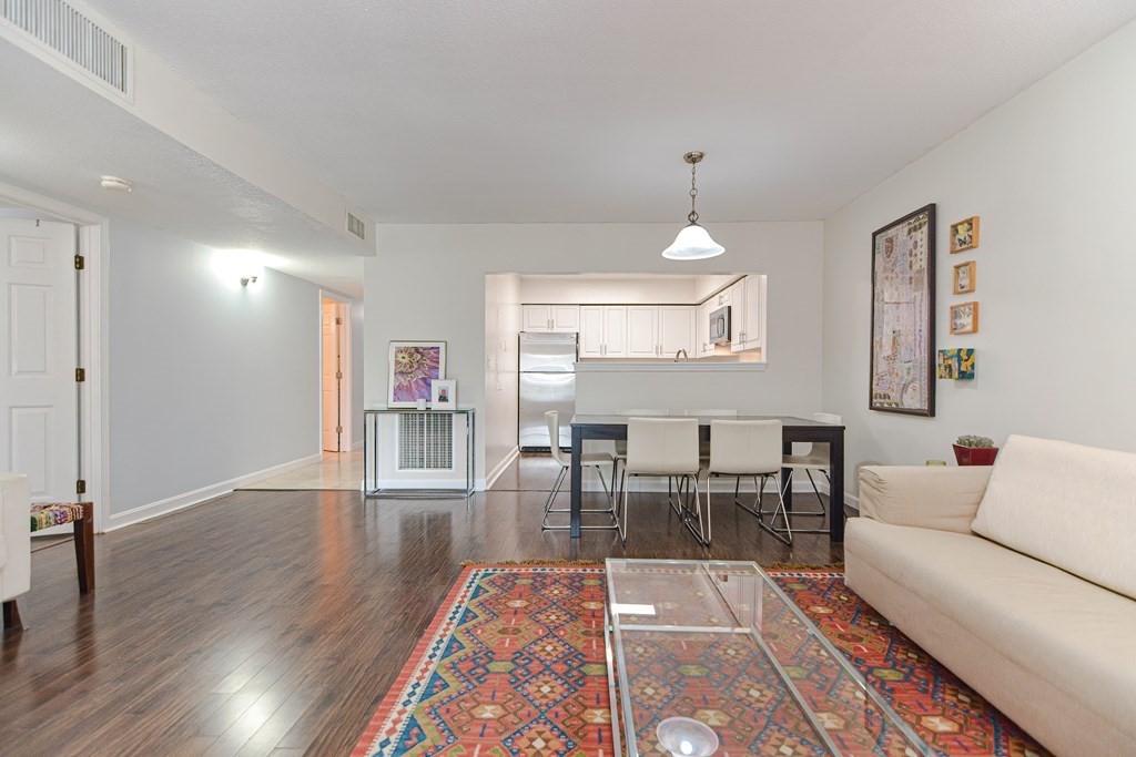 59 Brainerd Road, Unit 410 Boston, MA 02134 - Photo 15 of 41 a living room with furniture and a wooden floor
