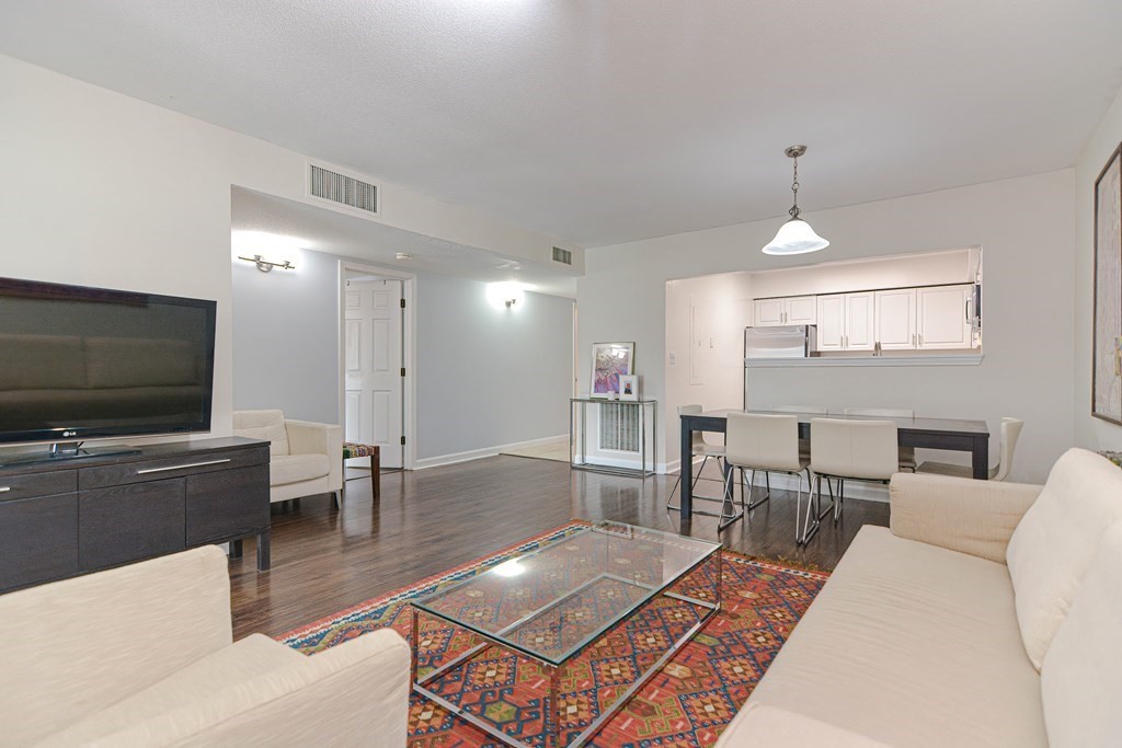 59 Brainerd Road, Unit 410 Boston, MA 02134 - Photo 16 of 41 a living room with furniture and a flat screen tv