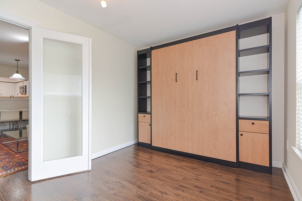 59 Brainerd Road, Unit 410 Boston, MA 02134 - Photo 20 of 41 an empty room with wooden floor and closet