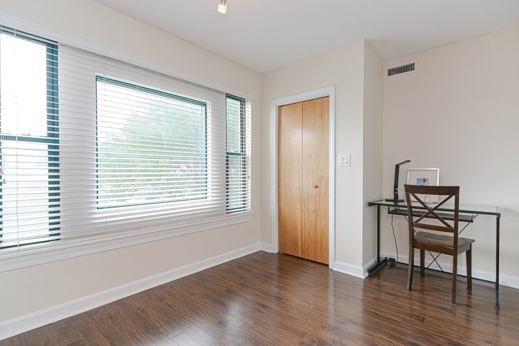 59 Brainerd Road, Unit 410 Boston, MA 02134 - Photo 22 of 41 a view of a livingroom with wooden floor and a window
