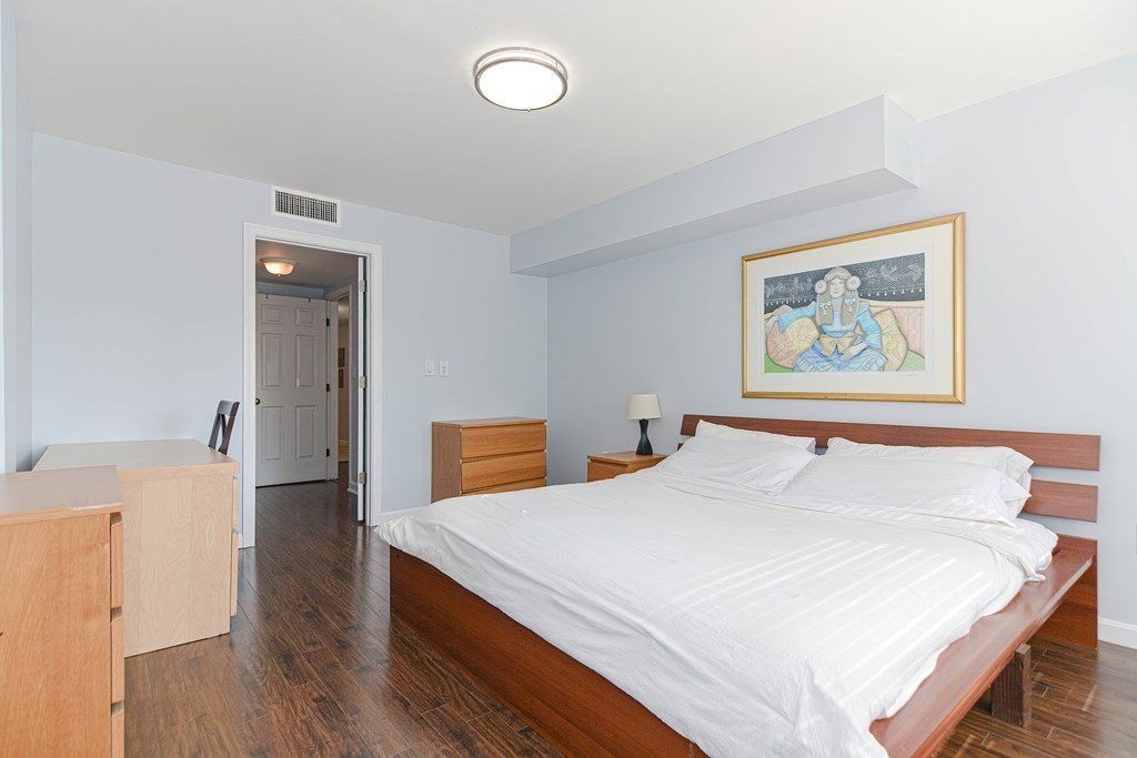 59 Brainerd Road, Unit 410 Boston, MA 02134 - Photo 25 of 41 a bedroom with a bed and a painting on the wall