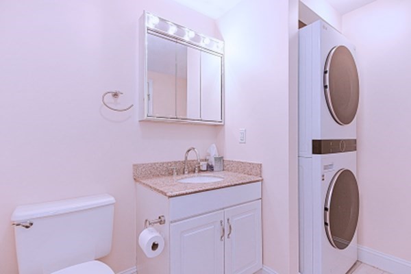 59 Brainerd Road, Unit 410 Boston, MA 02134 - Photo 29 of 41 a bathroom with a sink a vanity and a mirror