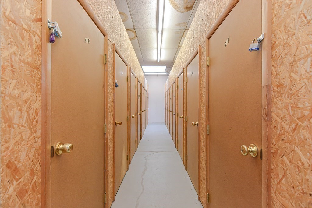 59 Brainerd Road, Unit 410 Boston, MA 02134 - Photo 33 of 41 a view of a hallway with wooden floor and staircase