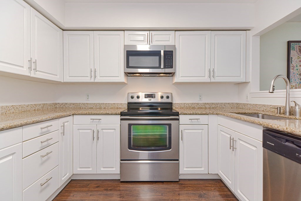 59 Brainerd Road, Unit 410 Boston, MA 02134 - Photo 10 of 41 a kitchen with white cabinets and stainless steel appliances