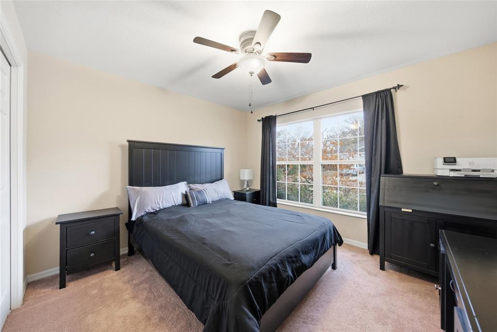 4066 Sundance Pl Loop Mulberry, FL 33860 - Photo 17 of 28 a bedroom with a large bed and a window