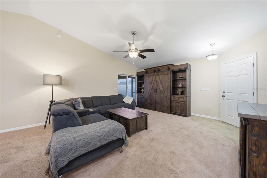 4066 Sundance Pl Loop Mulberry, FL 33860 - Photo 2 of 28 a living room with furniture and a ceiling fan