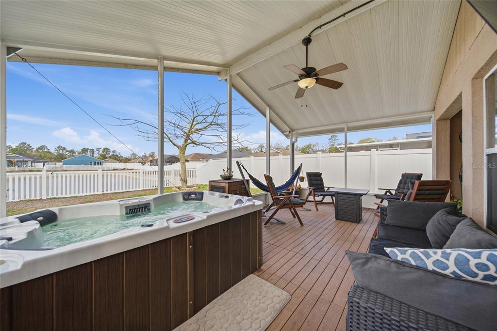 4066 Sundance Pl Loop Mulberry, FL 33860 - Photo 22 of 28 a living room with furniture a rug and a floor to ceiling window